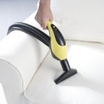 cleaning a sofa with a steam cleaner