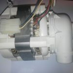 Disconnecting a faulty circulation pump in a dishwasher to replace it